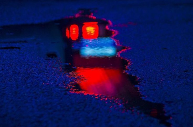An Artist Captures Beautiful - Lights Reflected in Puddle Night After Rain