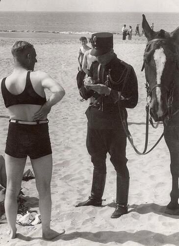 The Netherlands, 1931. A man on the beach is fined for wearing unseemly clothes.