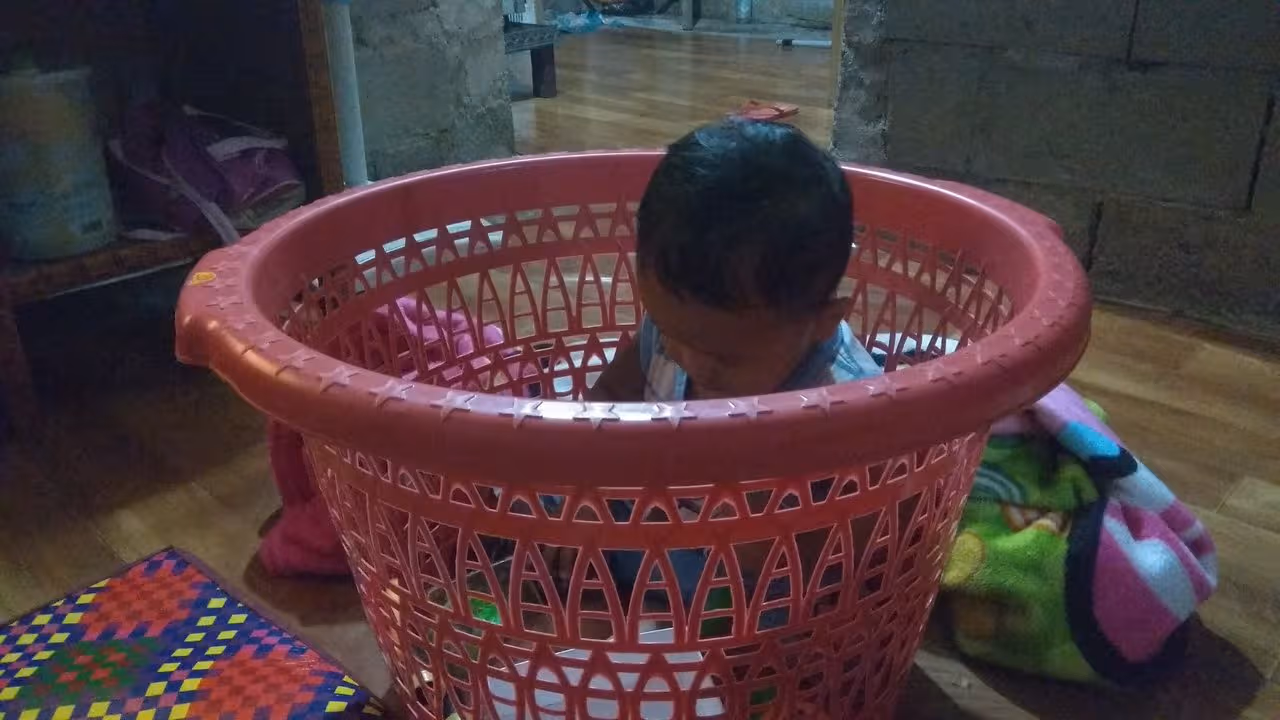 child sitting in the basket