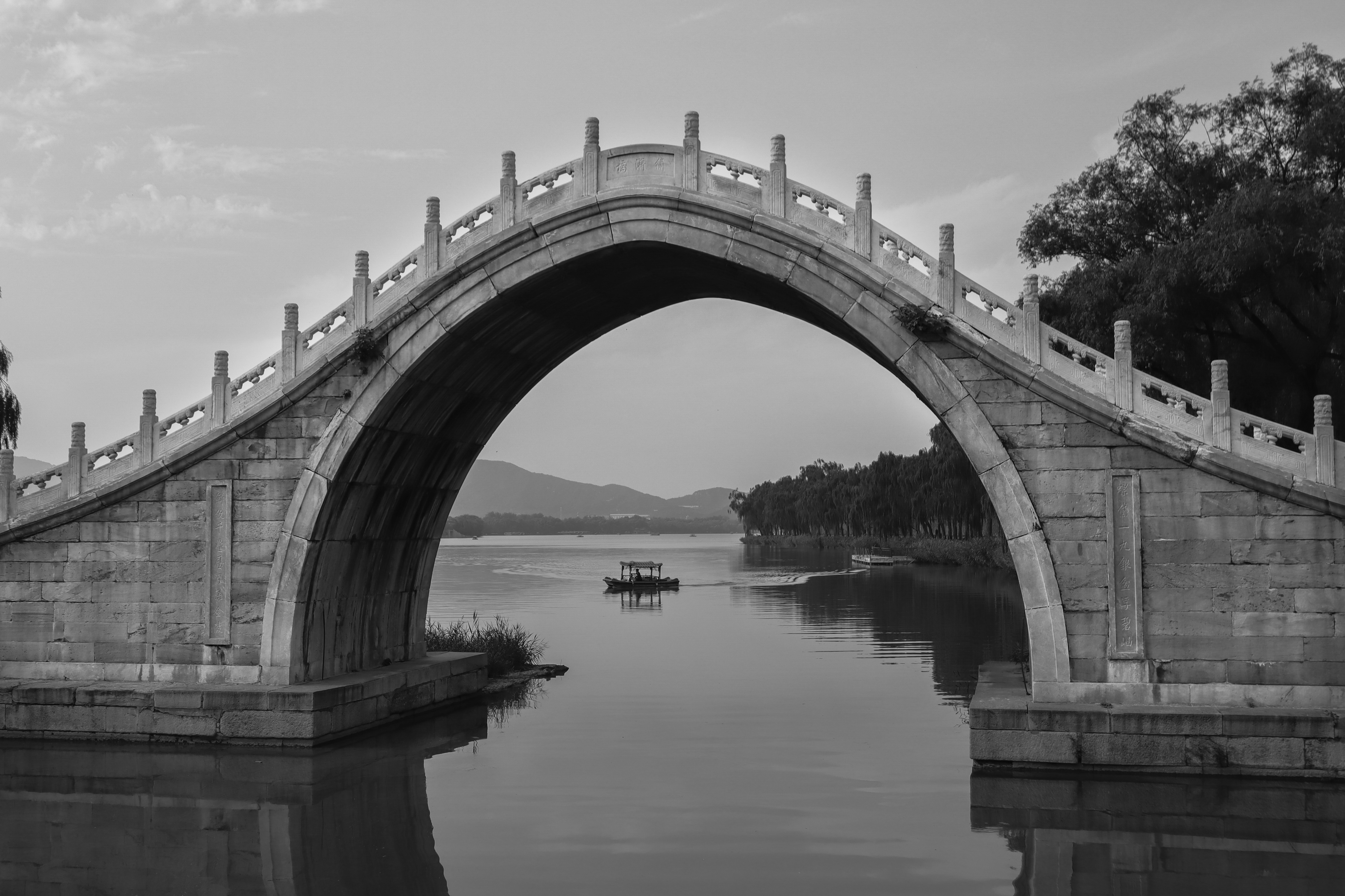 high_bent_stone_bridge_in_a_park_on_a_clear_day_1.jpg