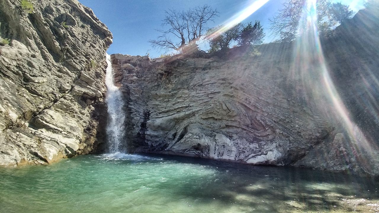 The green pool under the waterfall